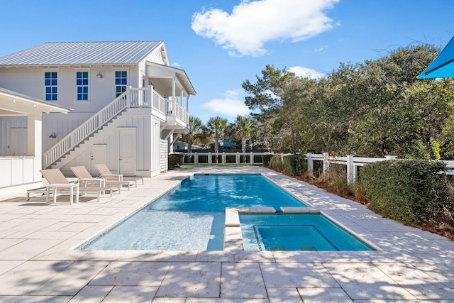 view of pool featuring an in ground hot tub and a patio