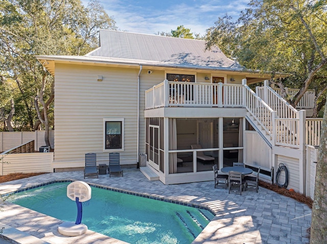 back of property featuring a patio area and a sunroom