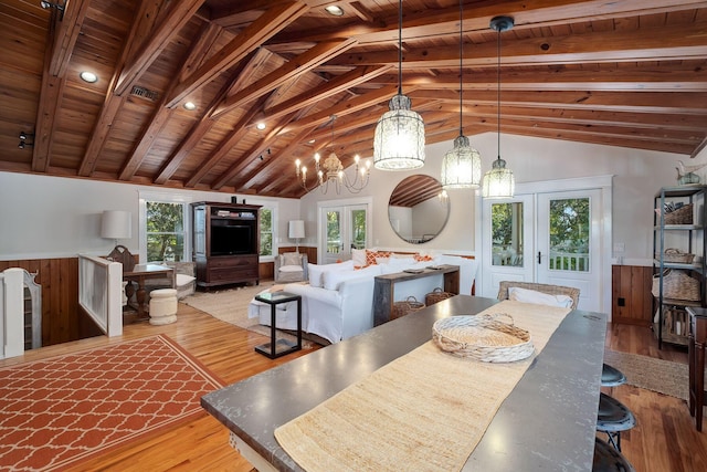 dining area with vaulted ceiling with beams, french doors, wooden ceiling, and light wood-type flooring