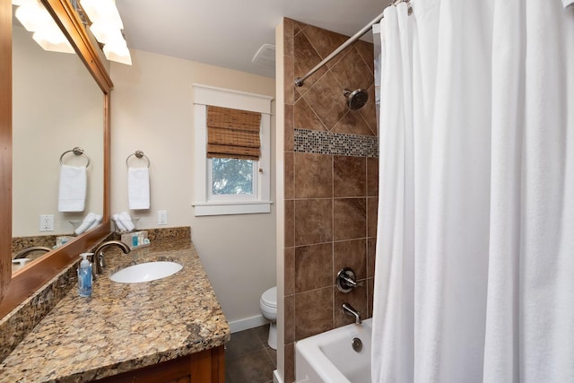 full bathroom with tile patterned floors, shower / bathtub combination with curtain, vanity, and toilet