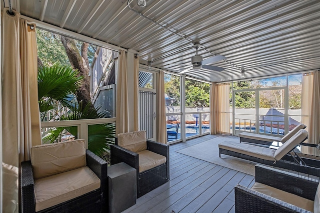 sunroom / solarium featuring a wealth of natural light and ceiling fan