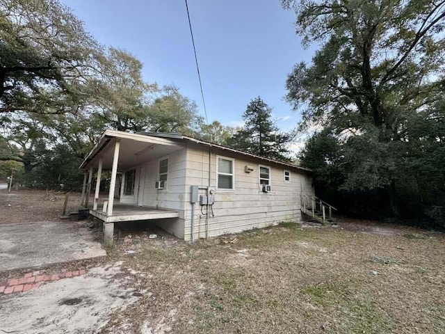 view of home's exterior featuring cooling unit and covered porch