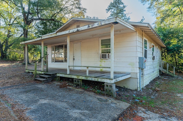 view of side of home with covered porch