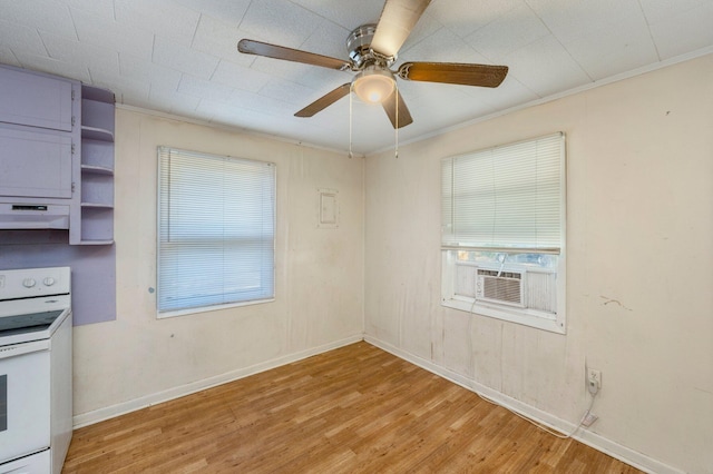 kitchen featuring cooling unit, white electric range, light hardwood / wood-style flooring, and a wealth of natural light