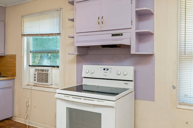 kitchen with cooling unit, white cabinets, and white range with electric stovetop