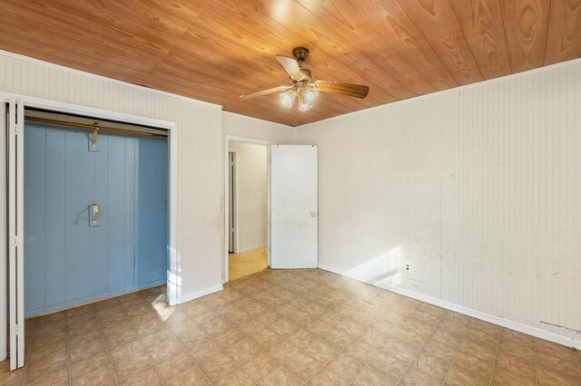 unfurnished bedroom featuring wood ceiling, ceiling fan, and a closet