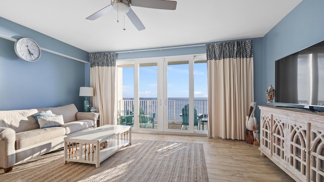 living room featuring ceiling fan and light hardwood / wood-style flooring