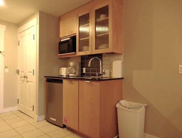 kitchen with stainless steel dishwasher, sink, light tile patterned floors, and backsplash