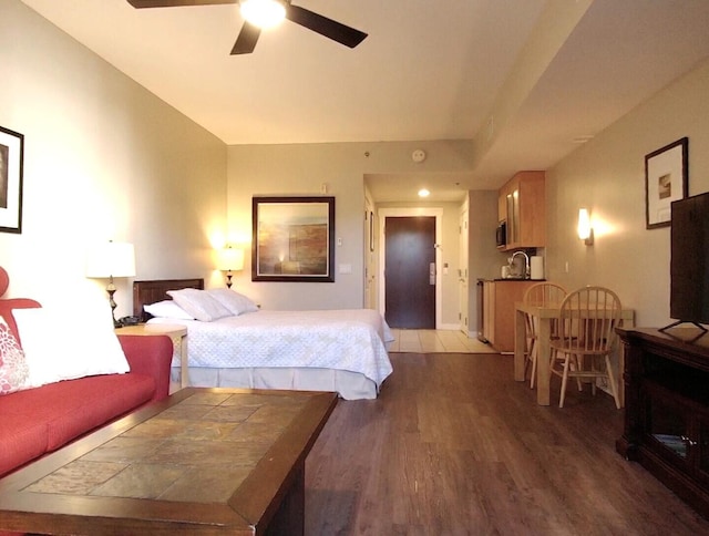 bedroom with ceiling fan, hardwood / wood-style floors, and sink