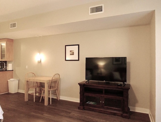 dining space with dark hardwood / wood-style flooring and sink