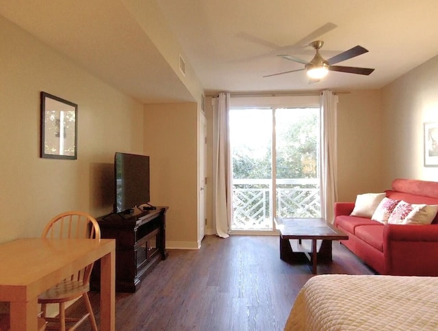 bedroom featuring dark hardwood / wood-style flooring, access to outside, and ceiling fan