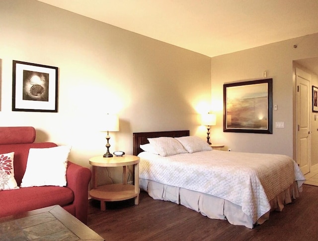 bedroom with dark hardwood / wood-style flooring