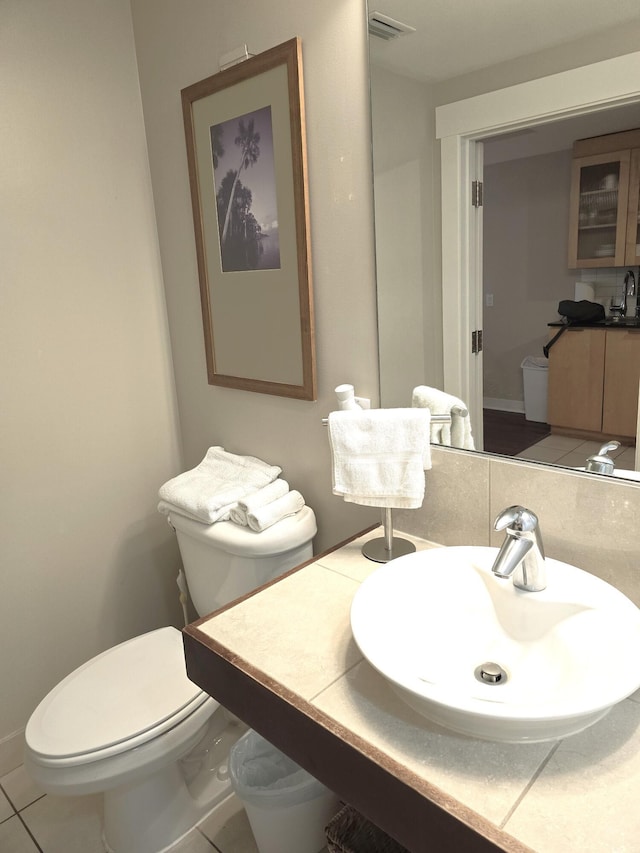 bathroom with tile patterned floors, vanity, toilet, and tasteful backsplash