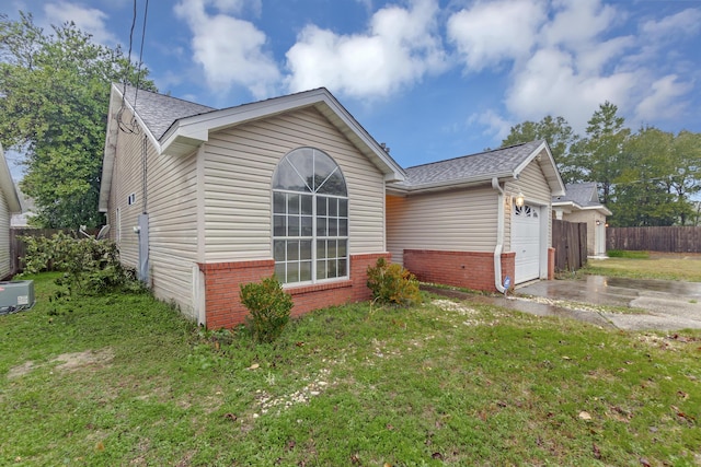 exterior space with a yard and a garage