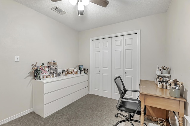 carpeted office with ceiling fan and a textured ceiling