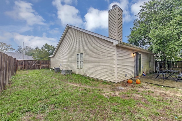 view of home's exterior featuring central AC unit and a lawn