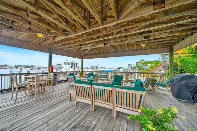 deck featuring outdoor lounge area, a water view, and grilling area