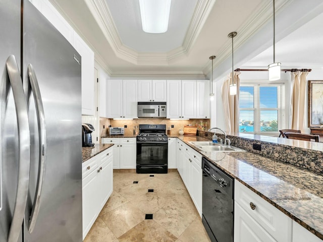 kitchen featuring pendant lighting, black appliances, white cabinets, dark stone countertops, and a tray ceiling