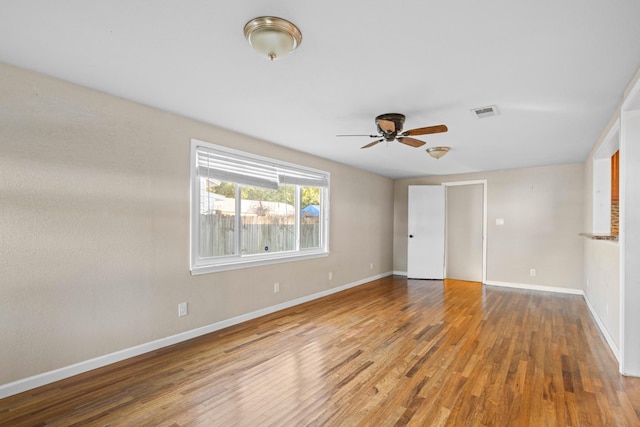 unfurnished room with ceiling fan and hardwood / wood-style floors