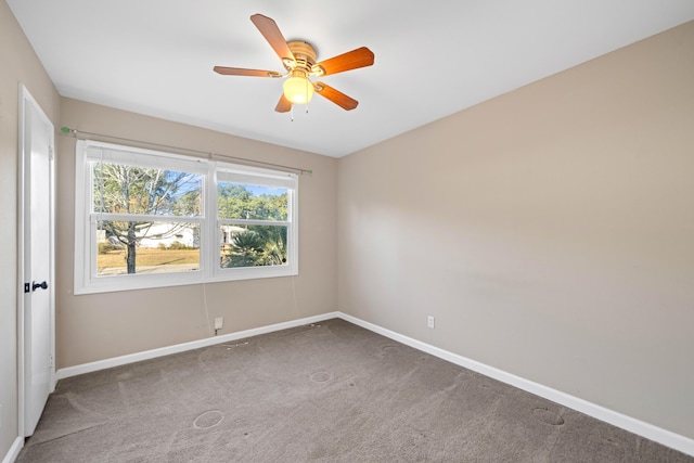 spare room featuring carpet flooring and ceiling fan