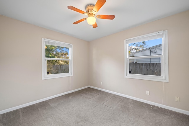 spare room featuring ceiling fan and carpet floors