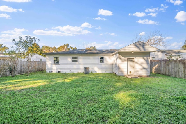 rear view of house featuring a yard