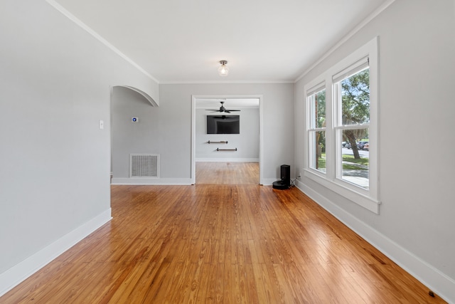 unfurnished living room featuring ceiling fan, ornamental molding, and light hardwood / wood-style flooring