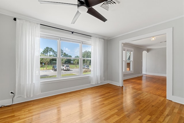 spare room featuring hardwood / wood-style floors, ceiling fan, and crown molding