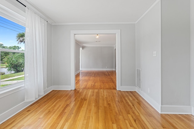 hall featuring light wood-type flooring and crown molding