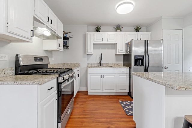 kitchen featuring white cabinetry, sink, light hardwood / wood-style floors, appliances with stainless steel finishes, and ornamental molding