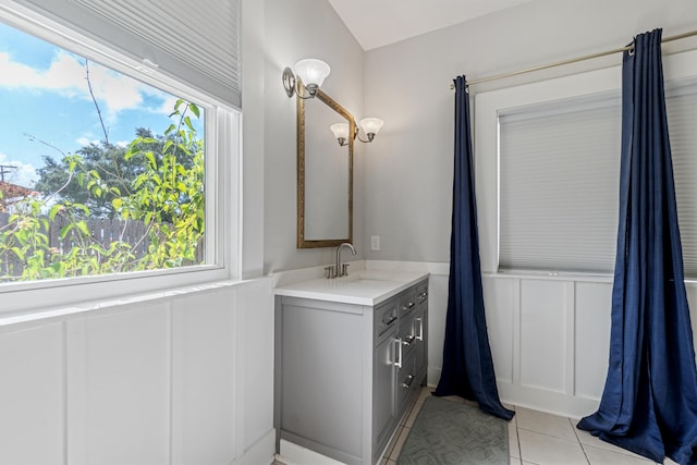 bathroom with tile patterned floors, vanity, and a wealth of natural light