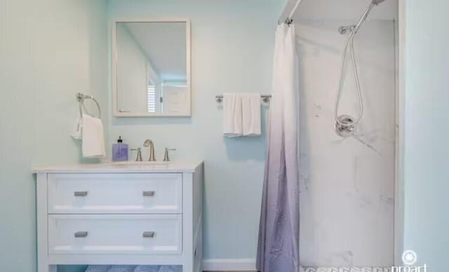 bathroom featuring vanity and curtained shower