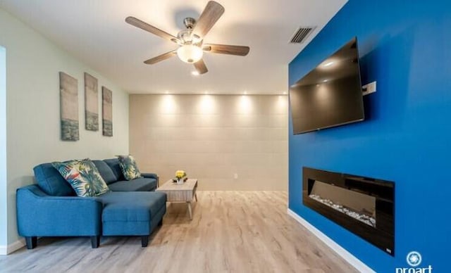 living room with hardwood / wood-style flooring and ceiling fan