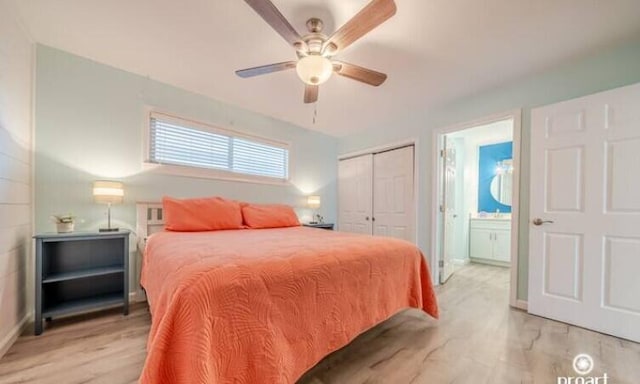 bedroom with ceiling fan, ensuite bath, a closet, and light hardwood / wood-style flooring