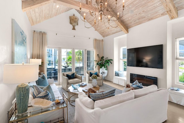 living room with a wealth of natural light, a chandelier, beamed ceiling, and wood ceiling