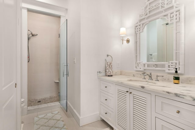 bathroom with tile patterned floors, vanity, and a shower with door