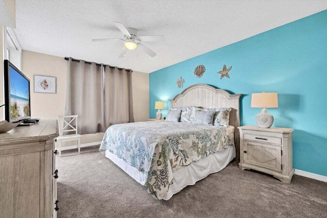 bedroom with ceiling fan, carpet, and a textured ceiling