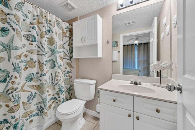 bathroom featuring a shower with curtain, vanity, a textured ceiling, tile patterned flooring, and toilet