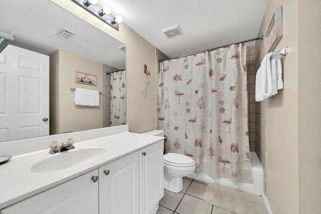 full bathroom with shower / bath combination with curtain, vanity, a textured ceiling, tile patterned flooring, and toilet