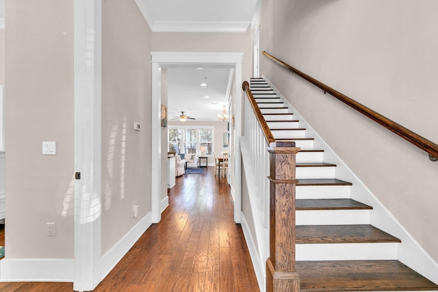 foyer featuring dark hardwood / wood-style flooring, ornamental molding, and ceiling fan