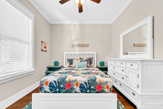 bedroom featuring crown molding, dark hardwood / wood-style floors, and ceiling fan