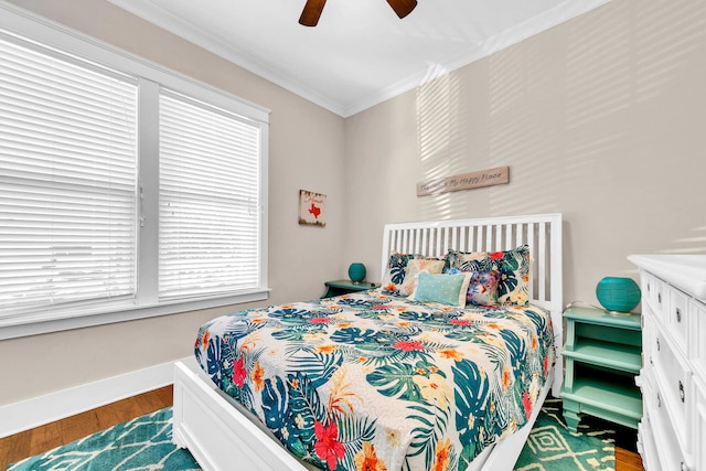 bedroom featuring crown molding, ceiling fan, and dark hardwood / wood-style flooring