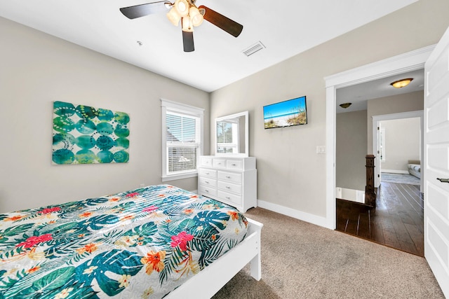 bedroom with ceiling fan and dark hardwood / wood-style flooring