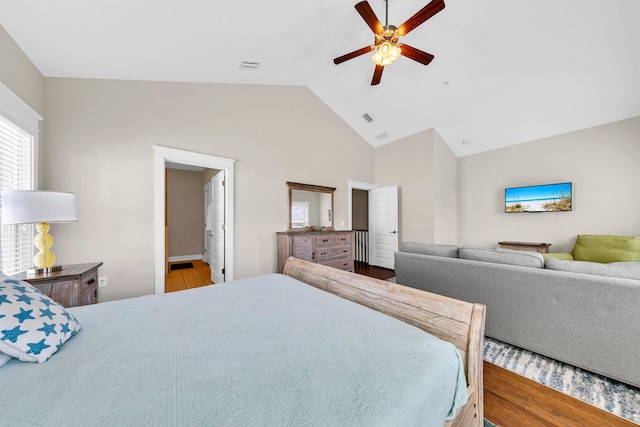 bedroom featuring ceiling fan, lofted ceiling, and light hardwood / wood-style flooring