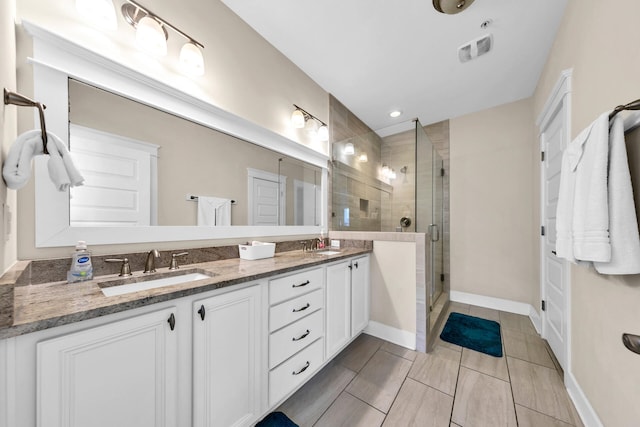 bathroom featuring vanity and a shower with shower door