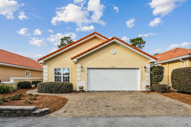 mediterranean / spanish home featuring a garage