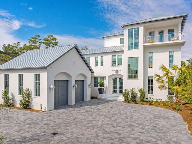 view of front of house featuring a balcony and a garage