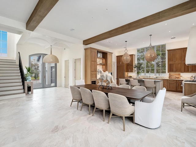 dining space with beamed ceiling