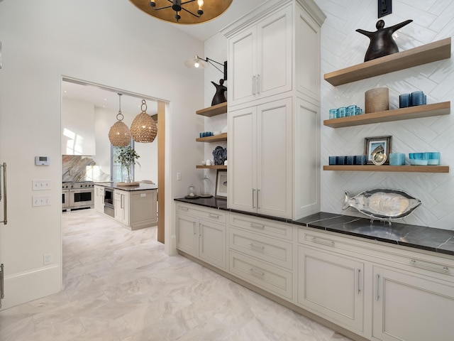 bar featuring decorative backsplash, high end stainless steel range, and hanging light fixtures