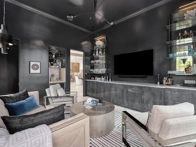 living room featuring ornamental molding and indoor bar